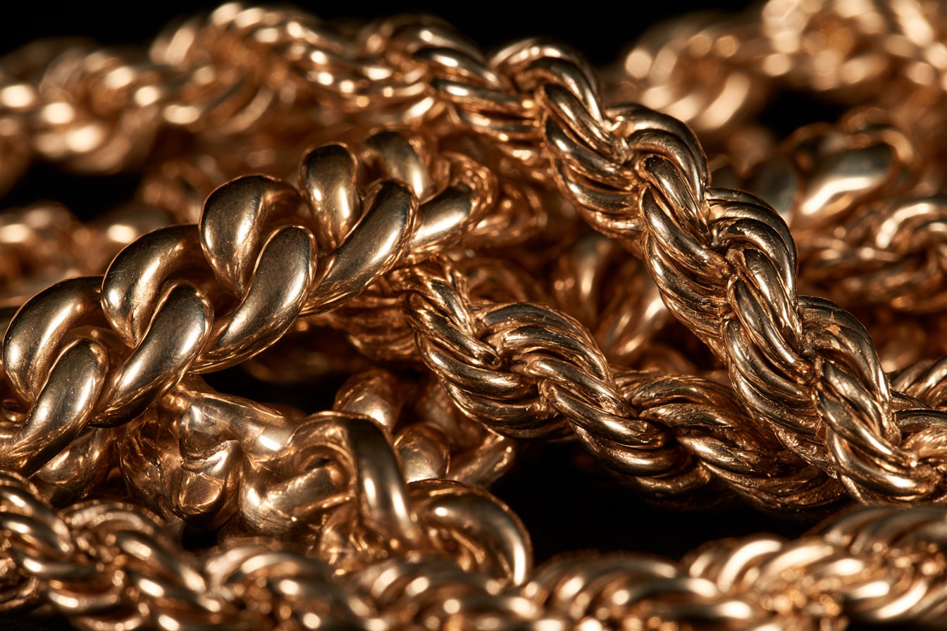 Macro of heavy gold chains on black